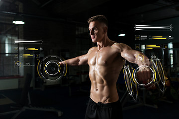 Image showing close up of man with dumbbells exercising in gym