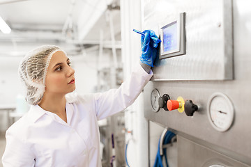 Image showing woman programming computer at ice cream factory