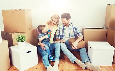 Image showing happy family with boxes moving to new home