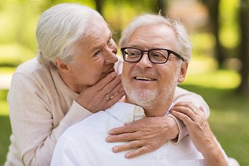 Image showing happy senior couple sitting on bench at park