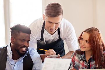 Image showing waiter and couple with menu at restaurant