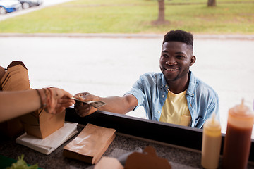 Image showing african american man buying wok at food truck