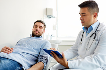 Image showing doctor and man with health problem at hospital