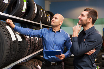 Image showing customer and salesman at car service or auto store