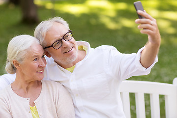 Image showing senior couple taking selfie by smartphone at park