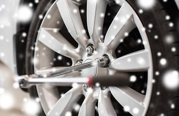 Image showing screwdriver and car wheel tire