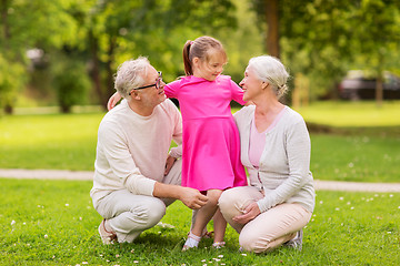 Image showing senior grandparents and granddaughter at park