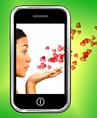 Image showing Girl Blowing Hearts From A Mobile Phone