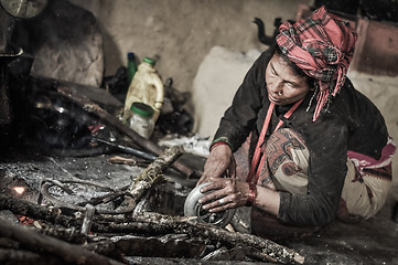 Image showing Kneeling woman in kitchen in Nepal