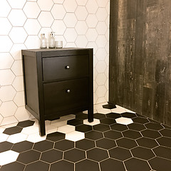 Image showing Spacious bathroom with tiled floor and black drawer unit