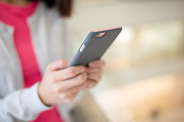 Image showing Woman browsing cellphone