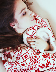 Image showing young pretty brunette girl in Christmas ornament blanket getting