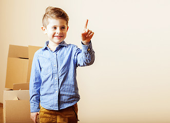 Image showing little cute boy in empty room, remoove to new house. home alone,