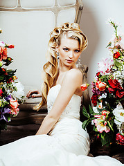 Image showing beauty young blond woman bride alone in luxury vintage interior with a lot of flowers 