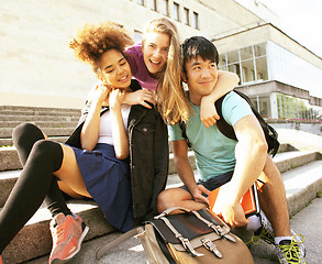 Image showing cute group teenages at the building of university with books huggings, back to school