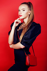 Image showing young pretty woman young lady posing on red background, lifestyle people concept