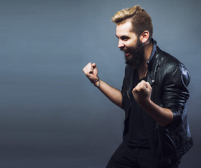 Image showing portrait of young bearded hipster guy smiling on gray background close up, lifestyle people concept 