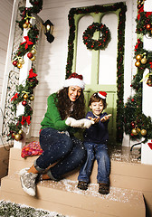 Image showing happy smiling family on Christmas at house with gifts, young mot