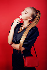 Image showing young pretty woman young lady posing on red background, lifestyle people concept