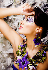 Image showing floral face art with anemone in jewelry, sensual young brunette 