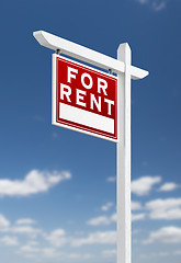 Image showing Left Facing For Rent Real Estate Sign on a Blue Sky with Clouds.