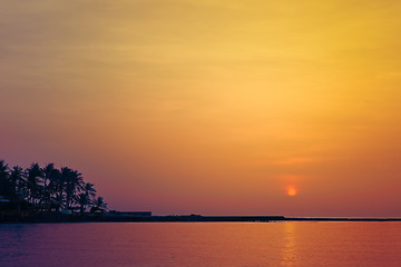 Image showing Beautiful colorful sunrise over sea and boulders seen under the 