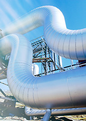 Image showing Industrial zone, Steel pipelines and valves against blue sky