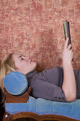 Image showing Beautiful Woman Reading a Magazine