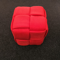 Image showing Modern red cube chair on gray carpet floor