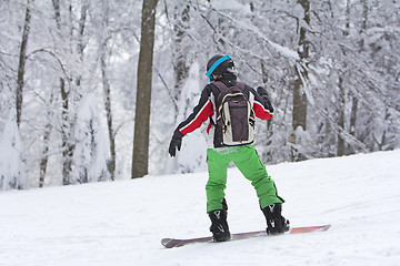 Image showing Winter sport snowboarder at ski slopeand alps mountains landscap