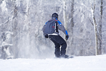 Image showing Winter sport snowboarder at ski slopeand alps mountains landscap