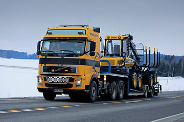 Image showing Yellow Volvo FH Truck Hauls Ponsse Forest Machinery