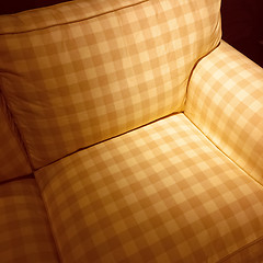 Image showing Checked armchair in spotlight