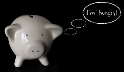 Image showing Piggy bank with thought bubbles, thinking I m hungry