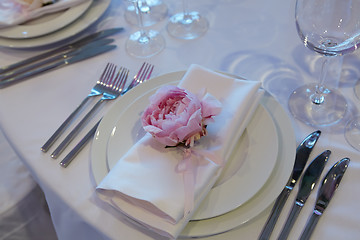 Image showing Spring table settings with fresh flower, napkin and silverware. Holidays background. Selective Focus.