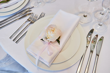 Image showing Spring table settings with fresh flower, napkin and silverware. Holidays background. Selective Focus.