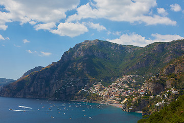 Image showing One of the best resorts of Italy with old colorful villas on the steep slope, nice beach, numerous yachts and boats in harbor and medieval towers along the coast, Positano.