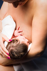 Image showing mother breast feeding her child