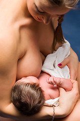 Image showing mother breast feeding her child