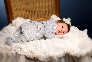 Image showing Newborn baby girl with sleeping on a wooden chair