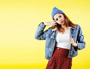 Image showing lifestyle people concept: pretty young school teenage girl having fun happy smiling on yellow background 