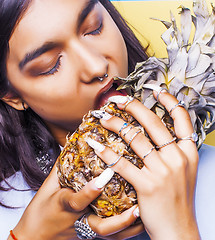 Image showing lifestyle people concept. young pretty smiling indian girl with pineapple, asian summer fruits 