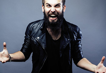 Image showing portrait of young bearded hipster guy on gray dark background close up, brutal modern man, lifestyle people concept 