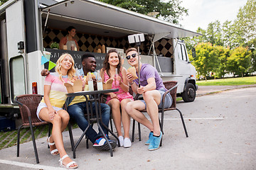 Image showing happy young friends taking selfie at food truck