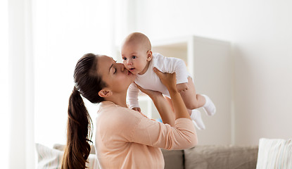 Image showing happy mother kissing little baby boy at home