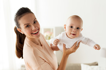 Image showing happy mother playing with little baby boy at home