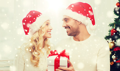 Image showing happy couple at home with christmas gift box