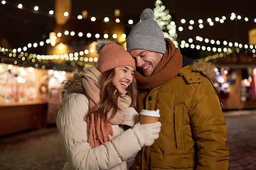 Image showing happy young couple with coffee at christmas market