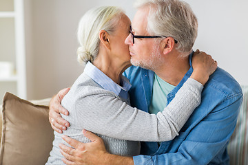 Image showing close up of happy senior couple hugging at home