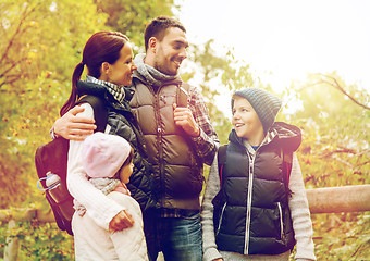 Image showing happy family with backpacks hiking